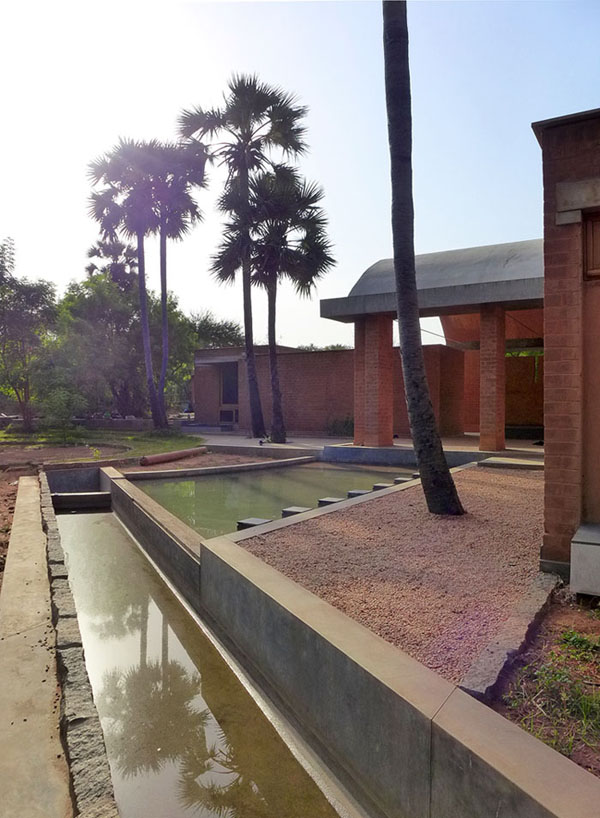 water channel and pond with palm trees at the entrance at sharanam pondicherry