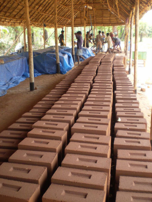 thousands of precise earth bricks made by local workers during the construction of sharanam pondicherry