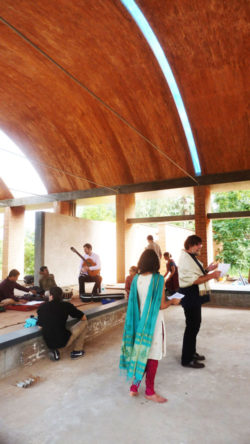 musicians rehearsing under tall brick vaults at sharanam pondicherry