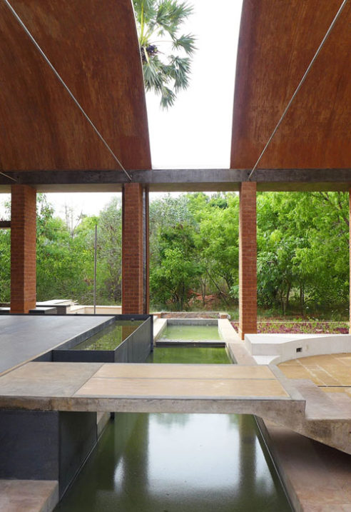 thin concrete bridge over long pond and brick vaults at sharanam pondicherry