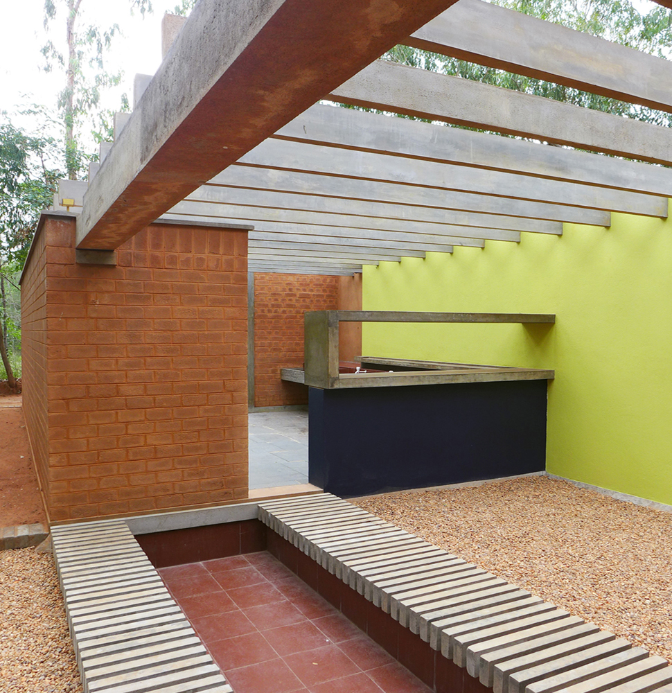 earth wall, green wall and pergolas over the kitchen courtyards at sharanam pondicherry community kitchen